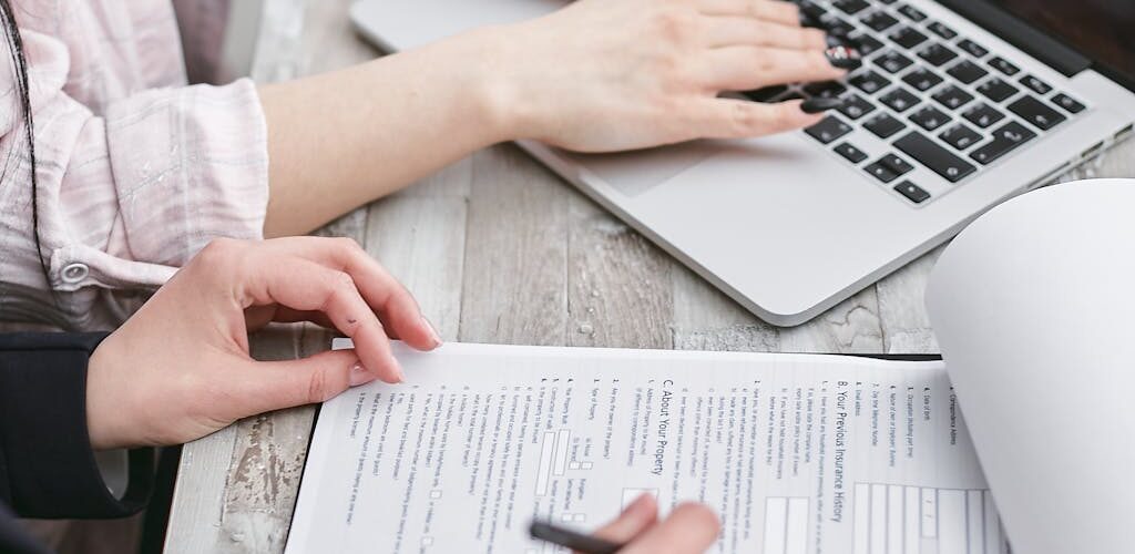 A Person Typing on Laptop