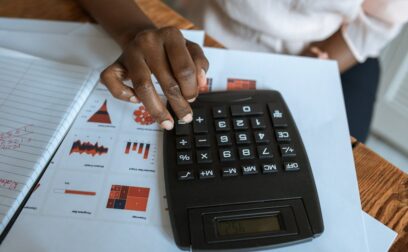 Person Using Black Desk Calculator