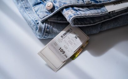 Jeans with price ticket on white table