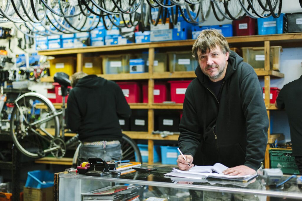 bicycle repair shop owner stood at the counter